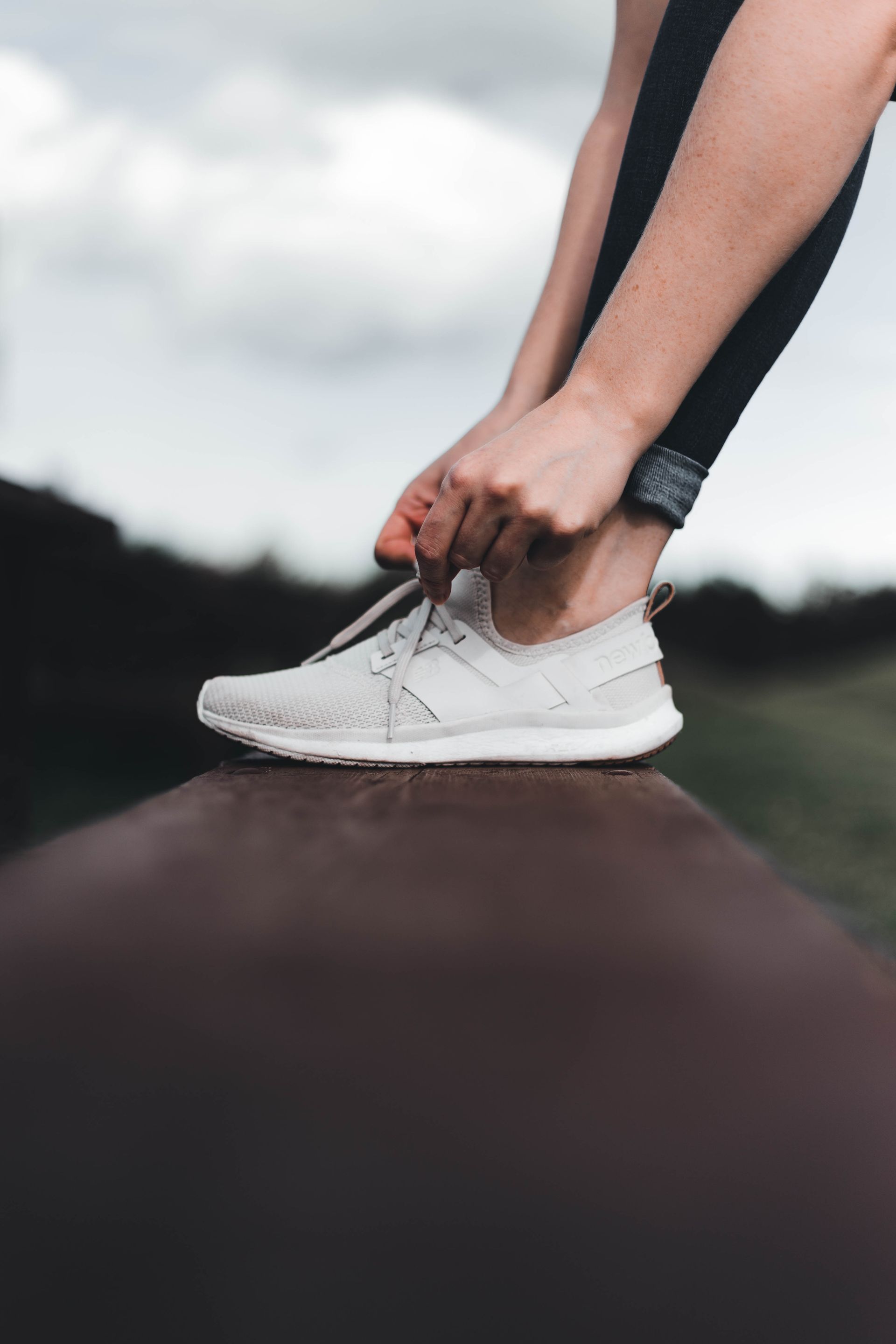 A person tying their trainers before getting active